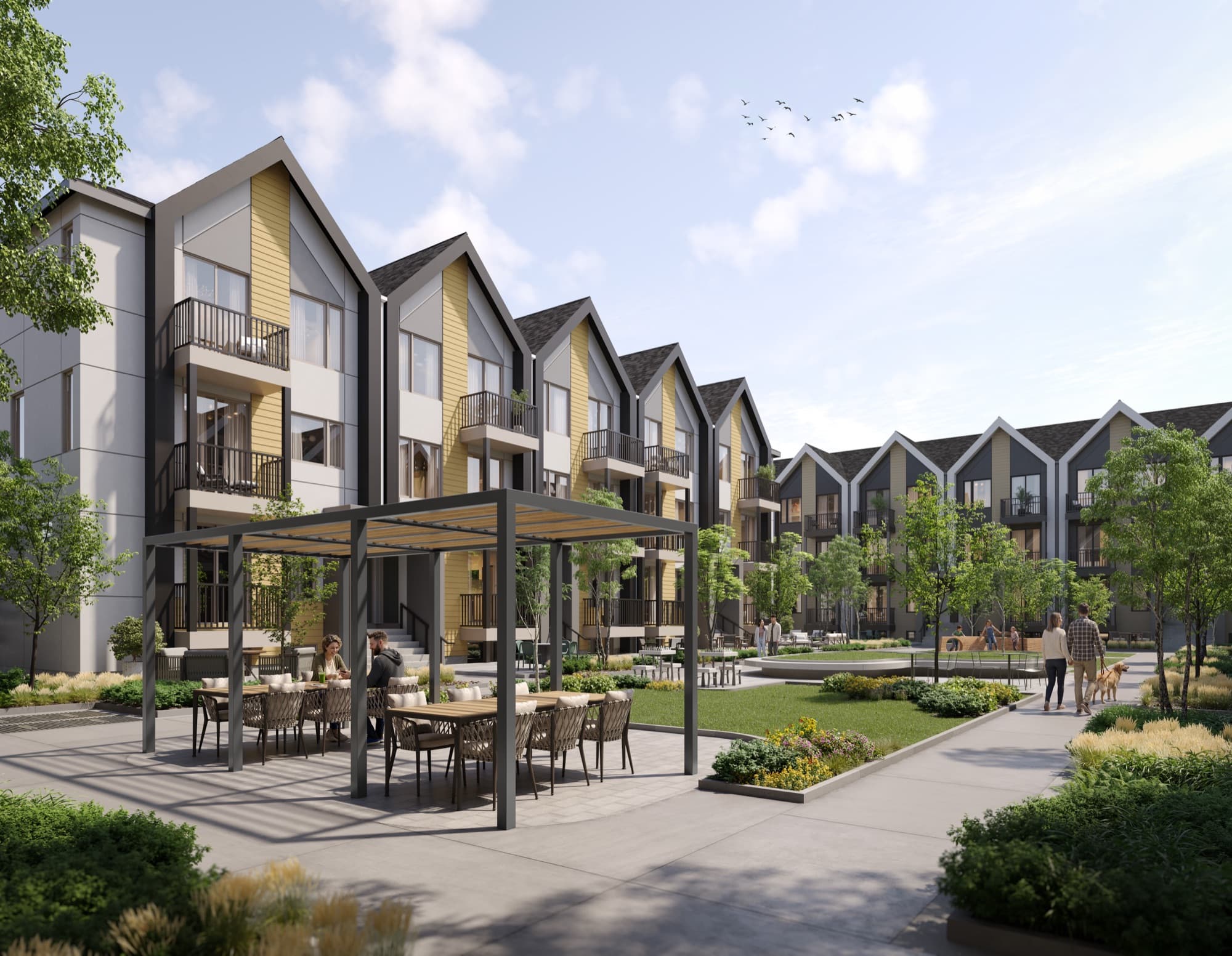Residents dining under a pergola in the shared courtyard between Aura town blocks